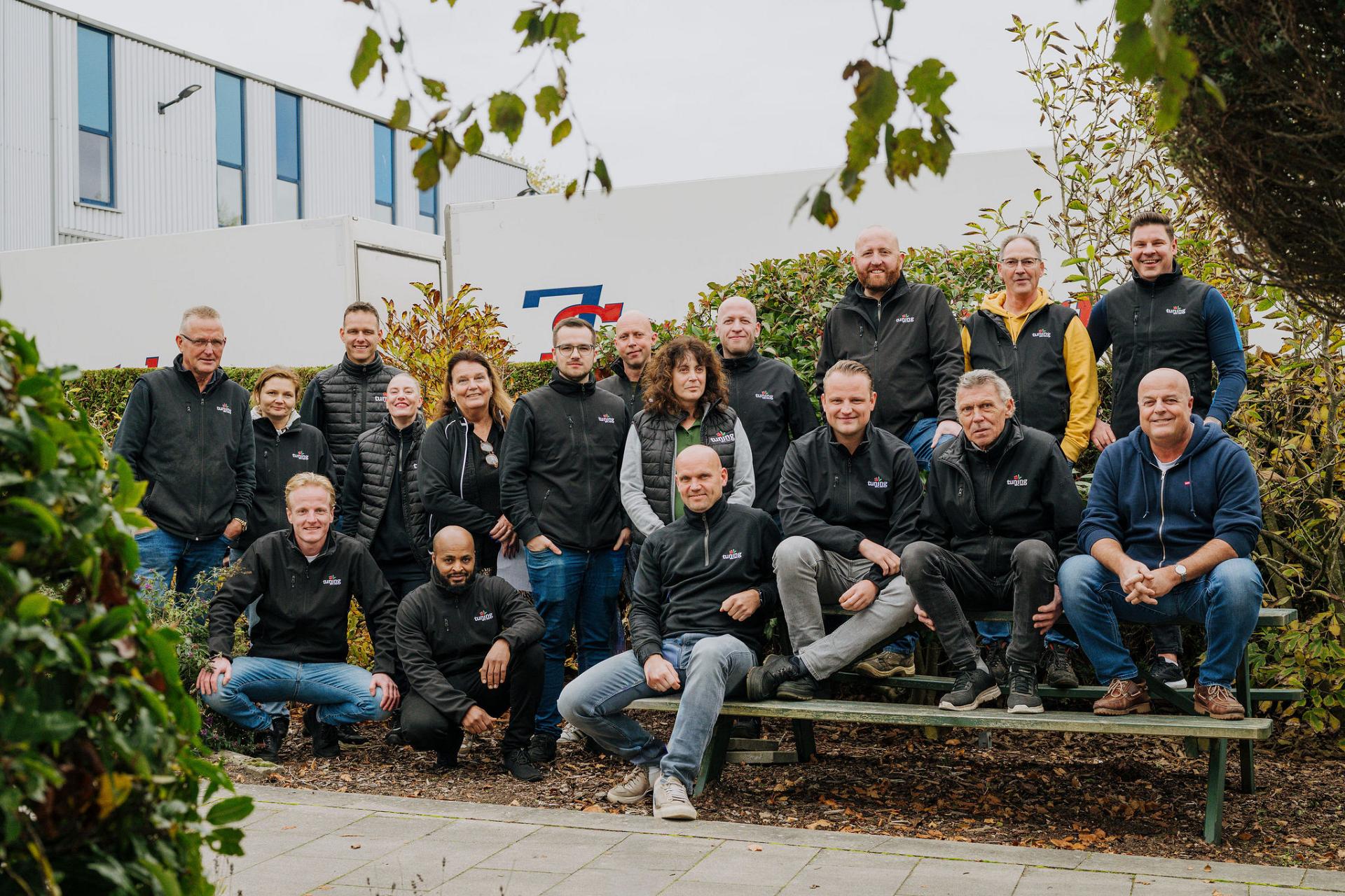 Group photo of the Tuning team standing and sitting together outside the company facility in Aalsmeer.
